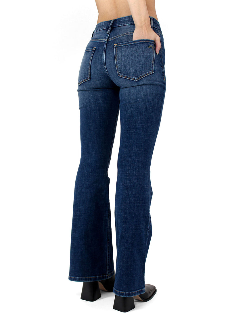 Back angle view of the Porter Blue Apparel Delilah Mid Rise Sustainable Denim Bootcut in Abbie Wash