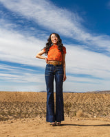 Model wearing orange blouse with ethically made denim Wanderer Flare in Rinse by Porter Blue Apparel
