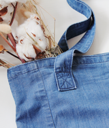  Closeup view of Weekender Denim Tote carrying cotton flowers by Porter Blue Apparel